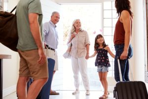 A family at front door preparing to go to holiday.