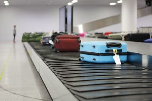 Luggage moving along the conveyor belt at the airport terminal.