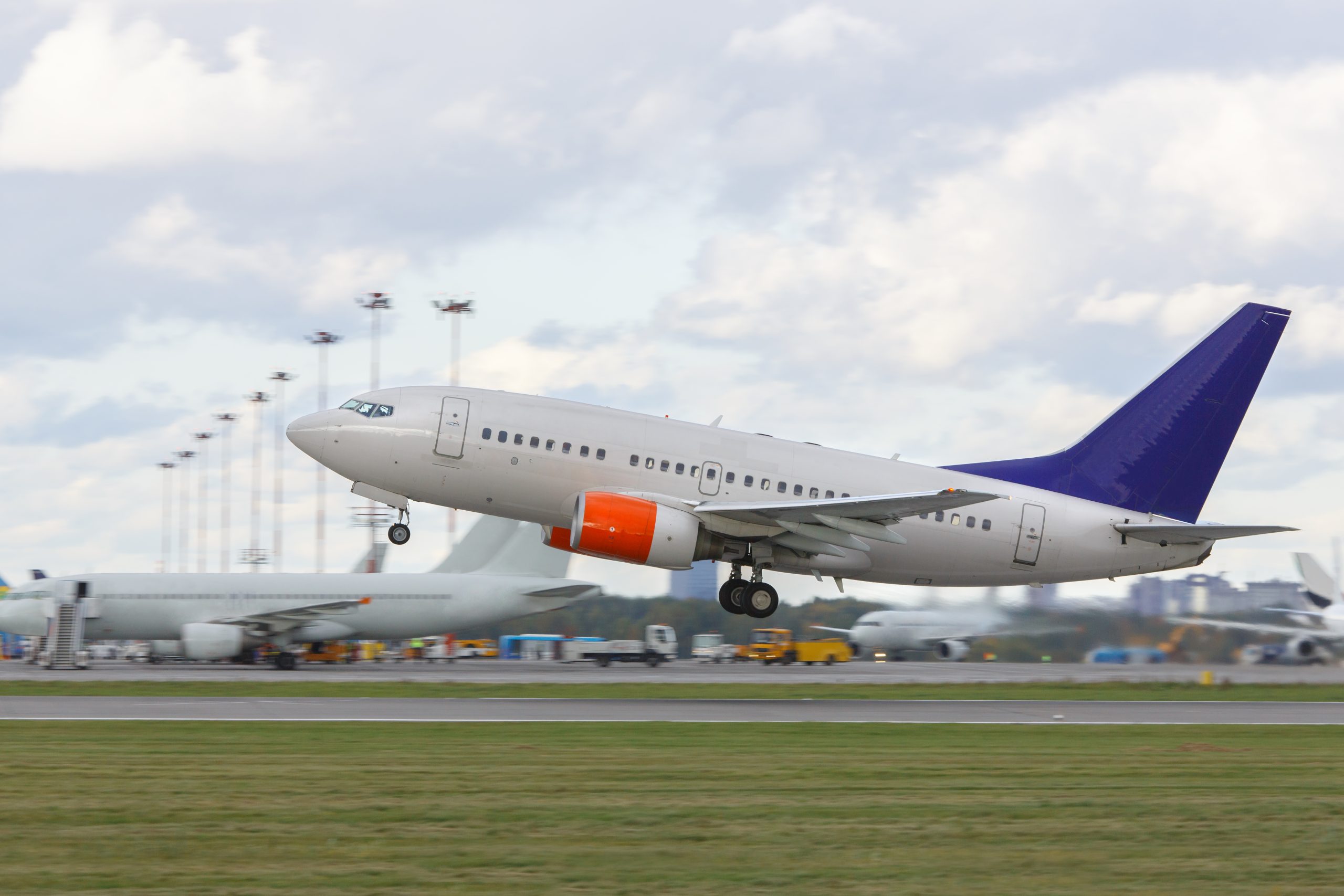 A modern passenger airplane taking off from the runway, representing seamless departures available with a Schiphol VIP Service.