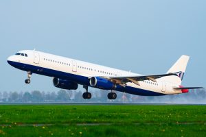 Airplane taking off from runway at Paris Charles de Gaulle Airport (CDG) in rainy weather