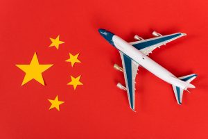 Toy airplane on Chinese flag symbolizing travel through airport pvg shanghai and international transit to China